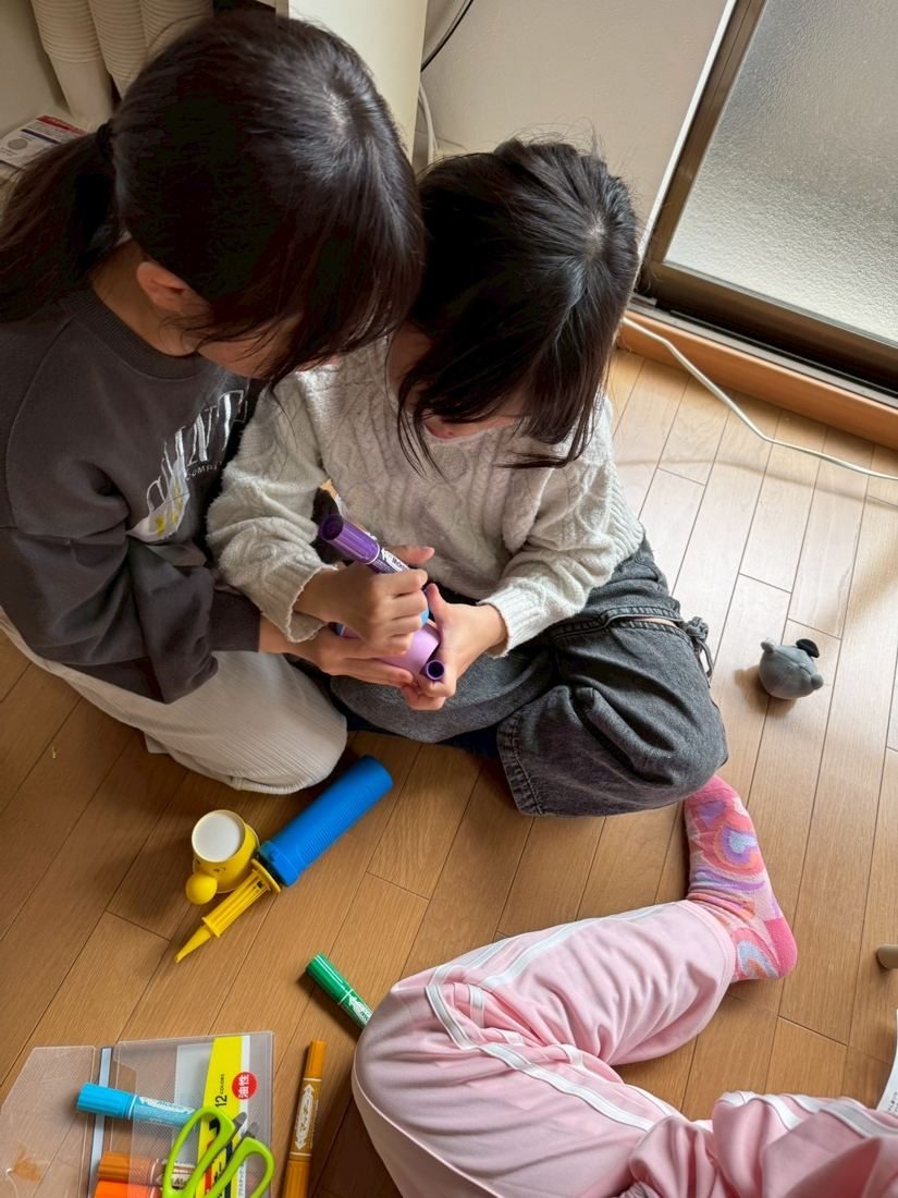 床で工作をする子どもたち